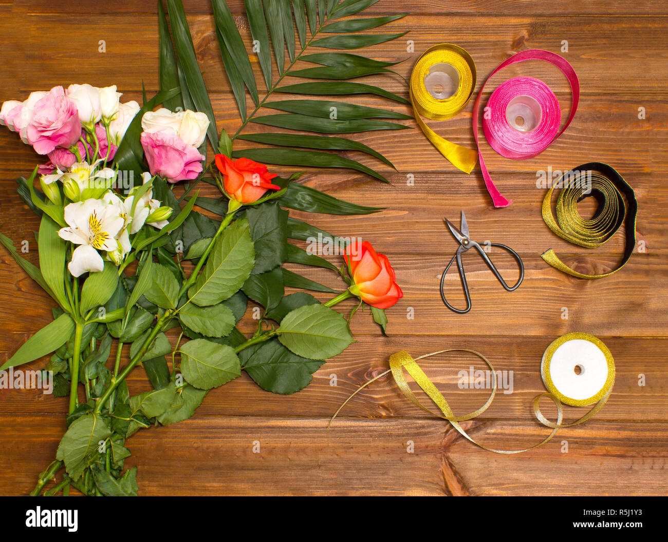 The florist desktop with working tools on wooden background Stock Photo