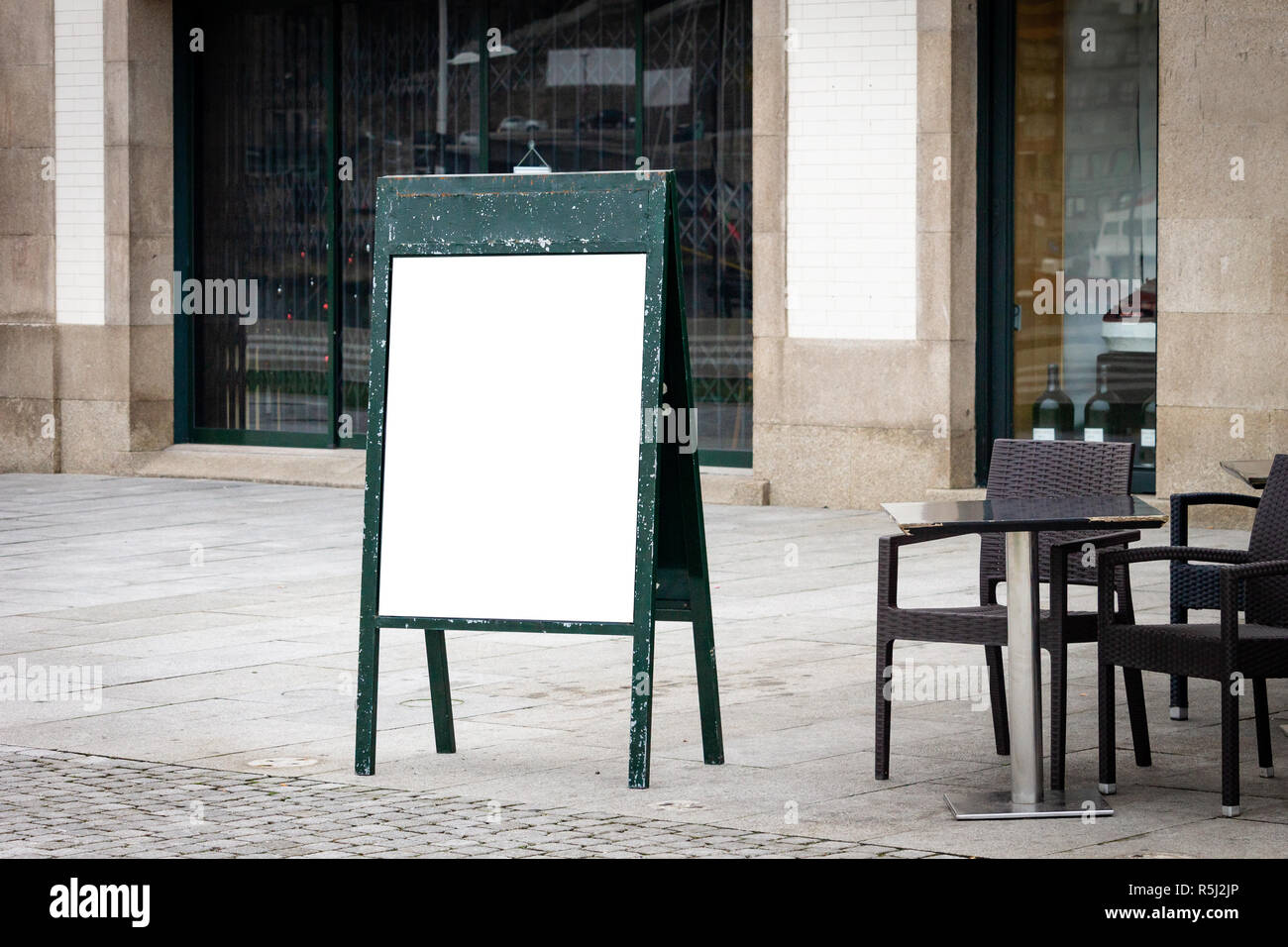 Restaurant cafe outdoor stand-up menu green sign mockup. Chairs and table on terrace. Stock Photo