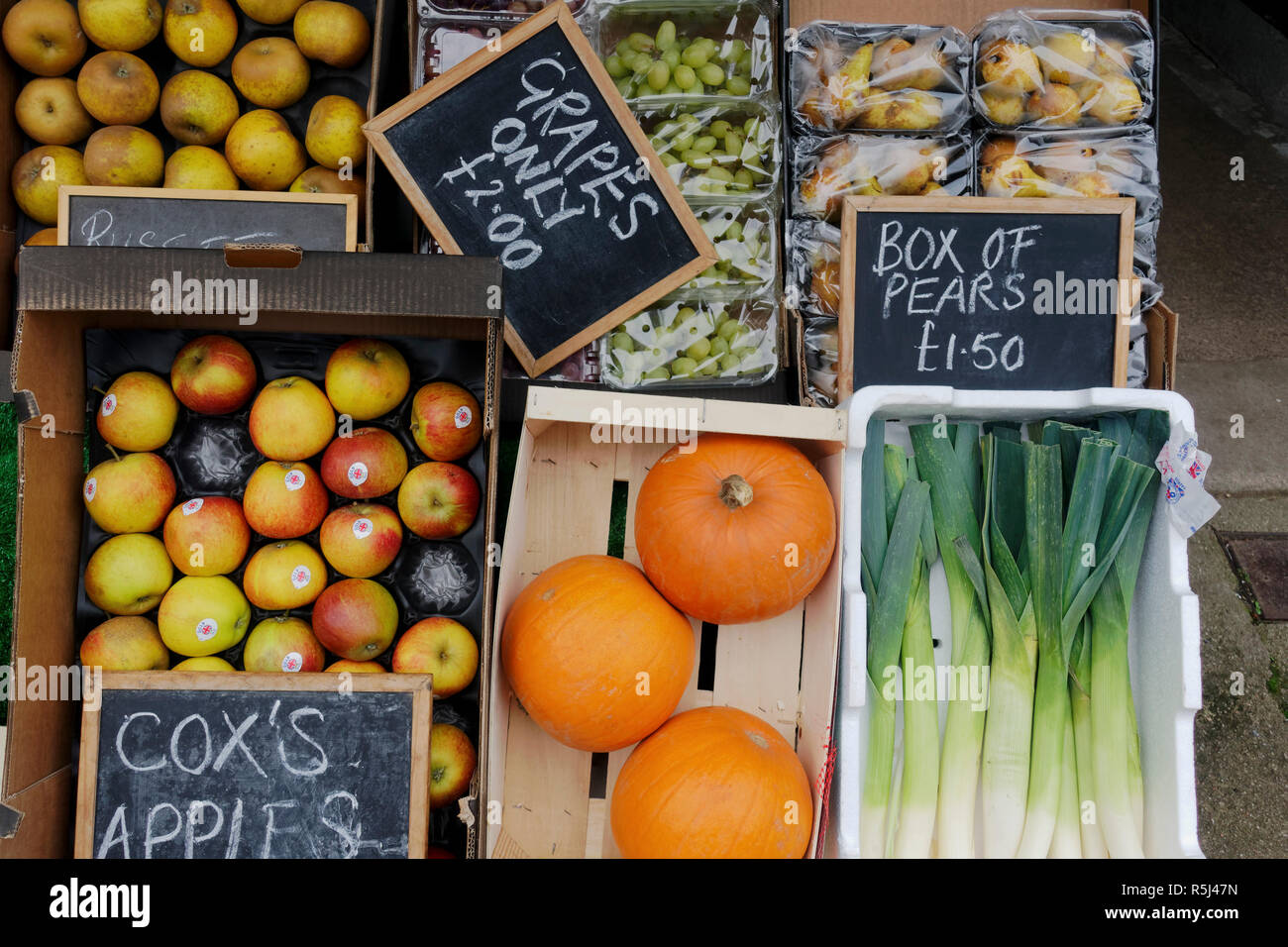 Display of boxes of fruit and vegetables outside greengrocers shop. Stock Photo