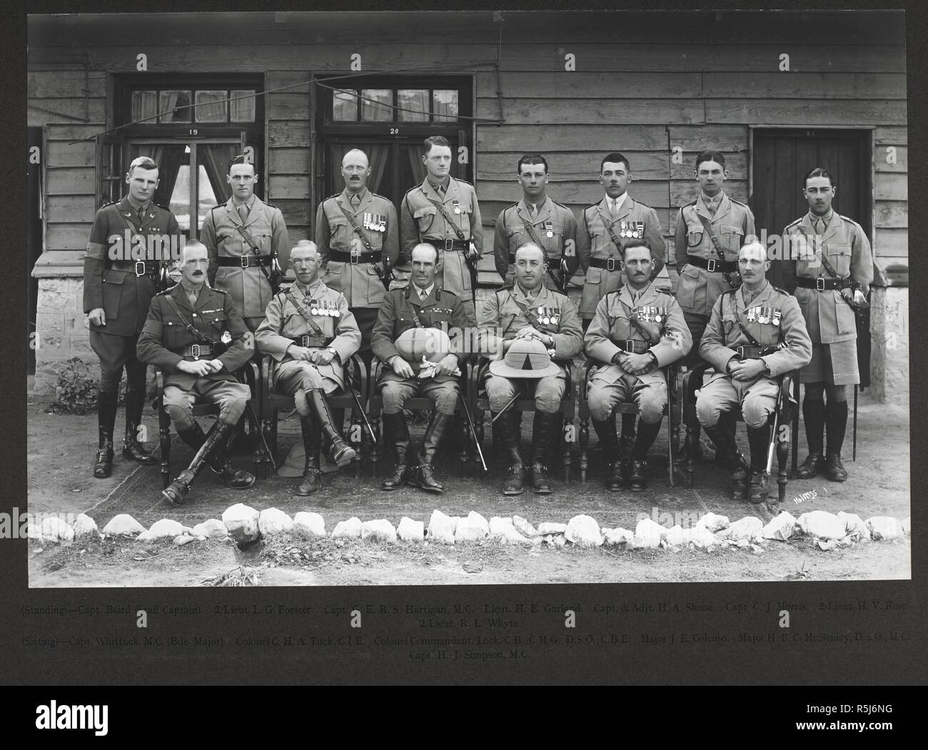 [Military group at Landi Khana.] 18 February 1926. Formally posed group portrait of British officers, taken after the unveiling of the Gurkha Centenary Bell. The sitters are identified as follows (Standing): Capt. Baird (Staff Captain); 2/Lieut L.G. Forster; Capt. G.E.R.S. Hartigan M.C.; Lieut. H.E. Garland; Capt. & Adjt. H.O. Skone; Capt. C.J. Morris; 2/Lieut H.V. Rose; 2/Lieut. R.L. Whyte. (Seated): Capt. Whittuck M.C. (Bde. Major); Colonel C.H.A. Tuck C.I.E.; Colonel Commandant Lock [sic for Loch] C.B., C.M.G., D.S.O., C.B.E.; Major J.E. Colenso; Major H.F.C. McSwiney D.S.O., M.C.; Capt. H. Stock Photo