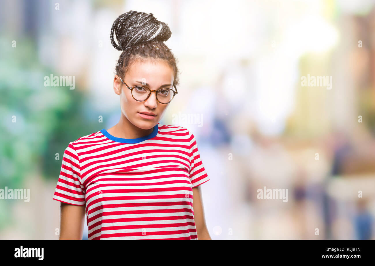 Young braided hair african american girl wearing glasses over isolated ...