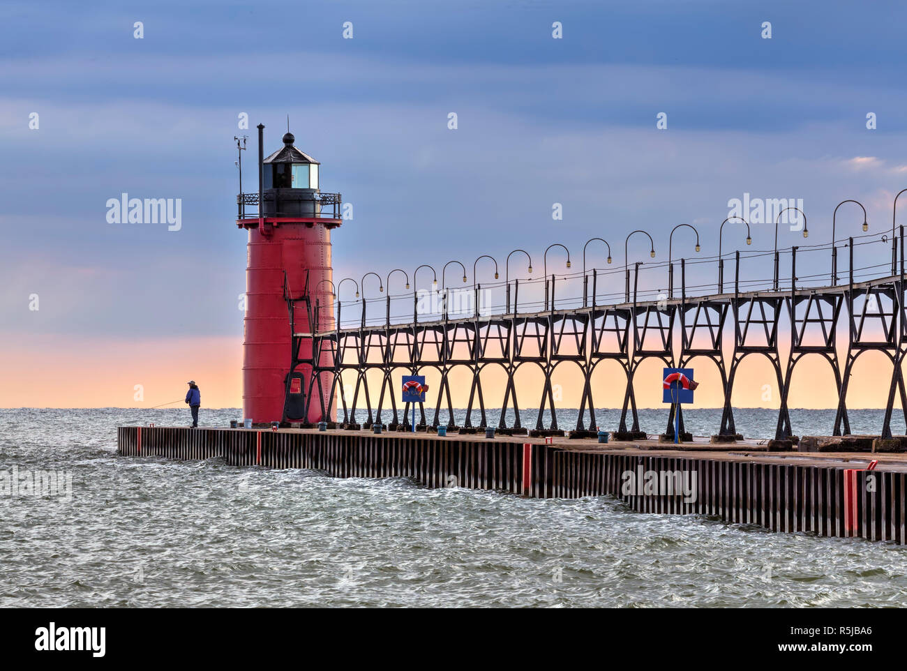 Evening skies begin to clear after a stormy afternoon at the South Haven, Michigan Lighthouse on Lake Michigan. Stock Photo
