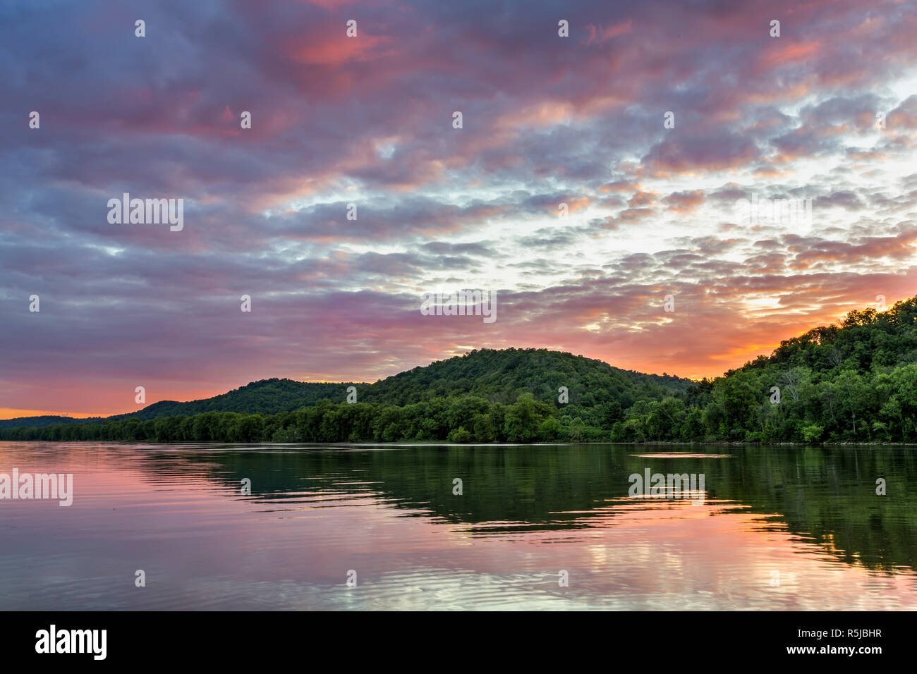 A colorful sunset sky is reflected on the Ohio River as photographed