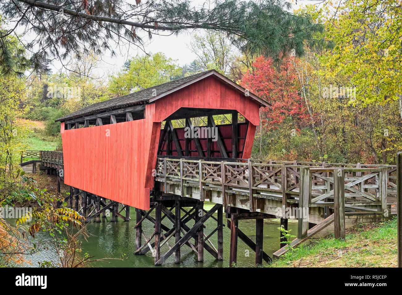 The historic Shaeffer Campbell Covered Bridge crosses College Pond on a campus in St. Clairsville, Ohio. Stock Photo