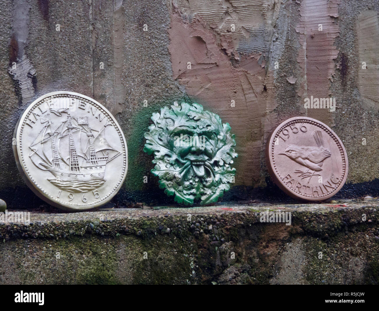 Green Man Deity Plaque & Large Replica British Half Penny & Farthing Coins, UK Stock Photo