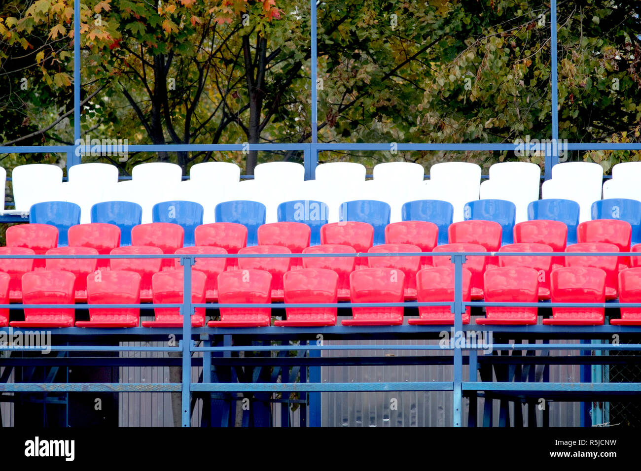 Grandstand stadium with many colored seats outdoors front view Stock