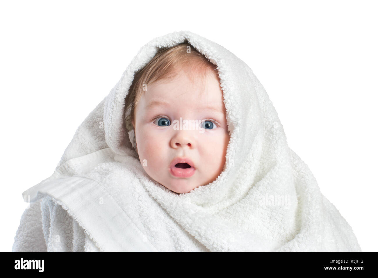 Cute surprised Baby in fluffy towel after bathing isolated on white background. Concept of hygiene, childcare. Stock Photo
