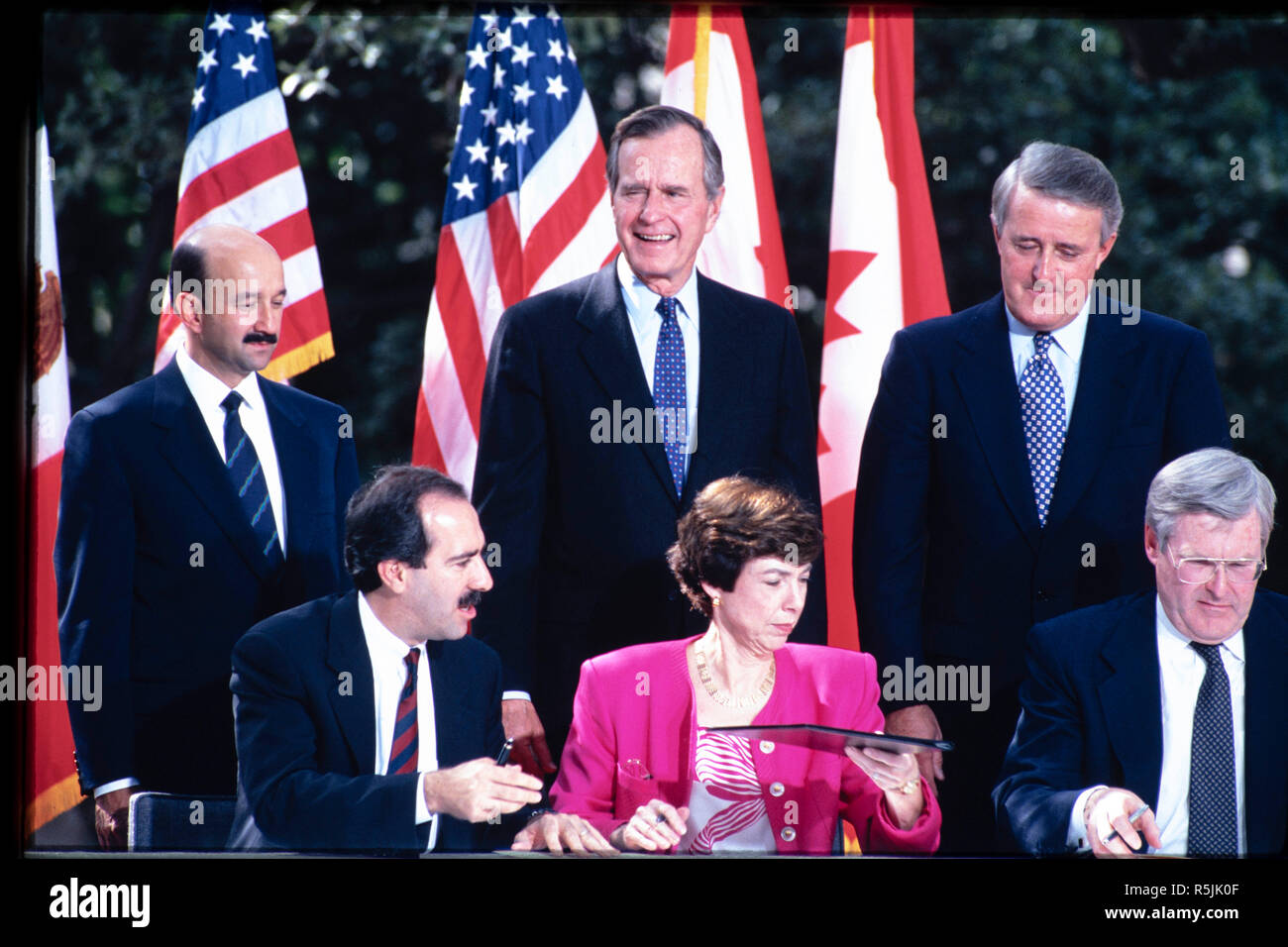 FILE October 1992: President George H.W. Bush, standing center, presides over the North America Free Trade Agreement (NAFTA) ceremonial signing in San Antonio. Former Pres. George H.W. Bush passed away Nov. 30, 2018 in Houston, TX. Credit: Bob Daemmrich/Alamy Live News Stock Photo