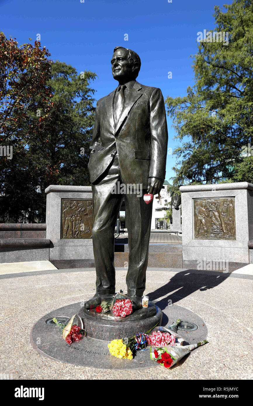Houston, USA. 1st Dec, 2018. Flowers are seen in front of a statue of former U.S. President George H.W. Bush in Houston, Texas, the United States, on Dec. 1, 2018. George H.W. Bush, the 41st president of the United States, has died Friday at the age of 94, according to a statement from his office. Credit: Steven Song/Xinhua/Alamy Live News Stock Photo