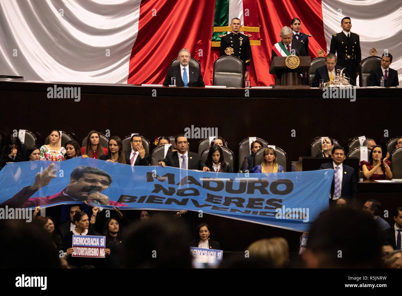 Mexiko Stadt, Mexico. 01st Dec, 2018. 'Maduro, you're not welcome', says the poster held up by a group of parliamentarians at the inauguration of left-wing politician Andres Manuel Lopez Obrador (3rd from right, top row). Lopez Obrador was the first left-wing president of Mexico in over 70 years to take the oath of office. Credit: Gerardo Vieyra/dpa/Alamy Live News Stock Photo