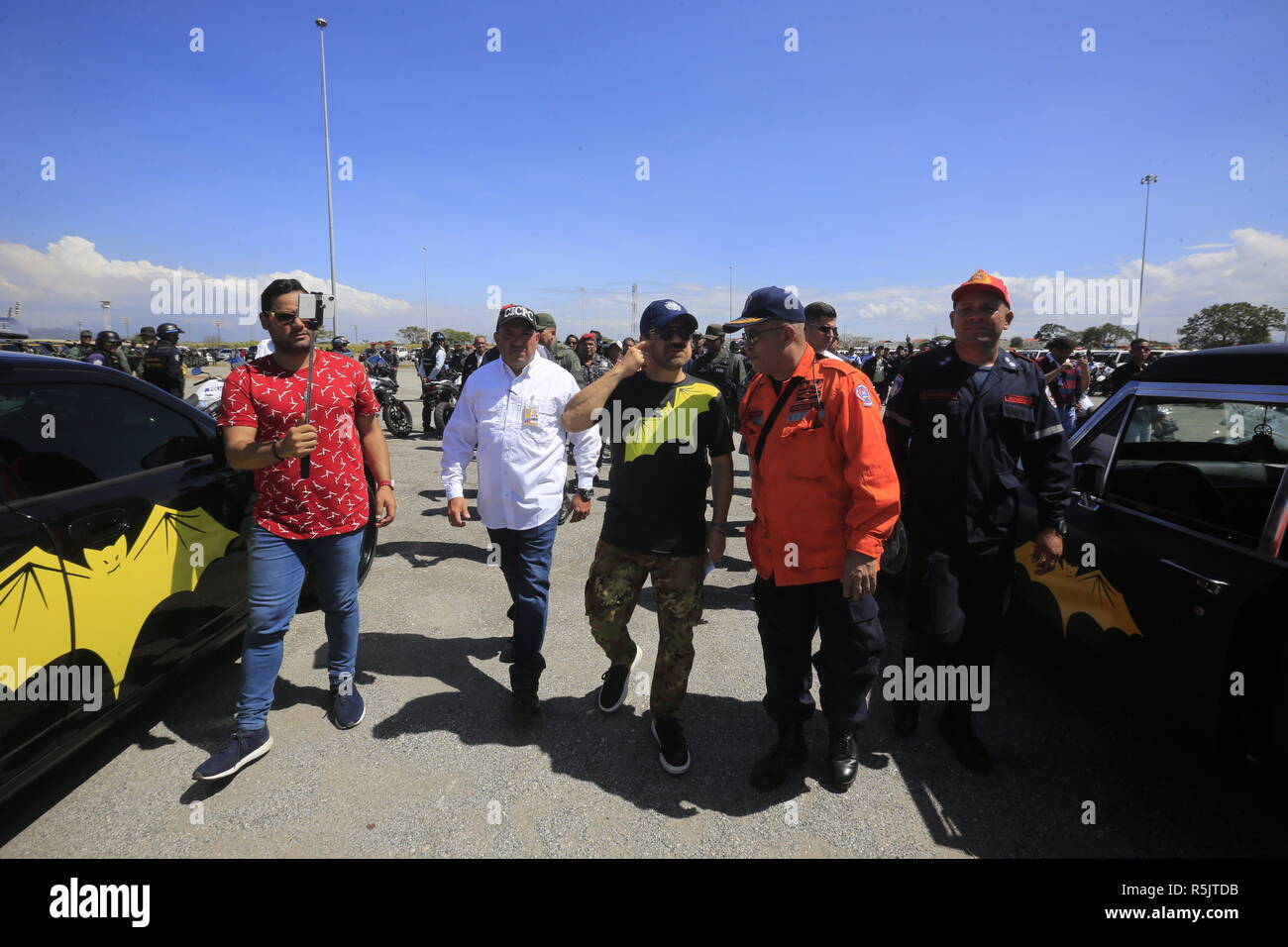 Valencia, Carabobo, Venezuela. 1st Dec, 2018. December 01, 2018. Rafael Lacava (2-r) governor of Carabobo state, walks between the two versions of Dracula's car.during the star of the security operation Safe Christmas, in Valencia, Carabobo state. Photo: Juan Carlos Hernandez Credit: Juan Carlos Hernandez/ZUMA Wire/Alamy Live News Stock Photo