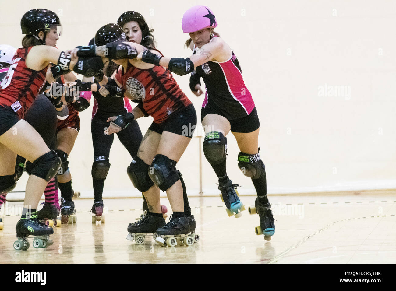 Madrid, Spain. 1st December, 2018. Jammer of Lisboa Troopers Roller Derby,  #707 Handsome Shark, jumping to avoid the blockade of Roller Derby Madrid B  players. © Valentin Sama-Rojo/Alamy Live News Stock Photo -
