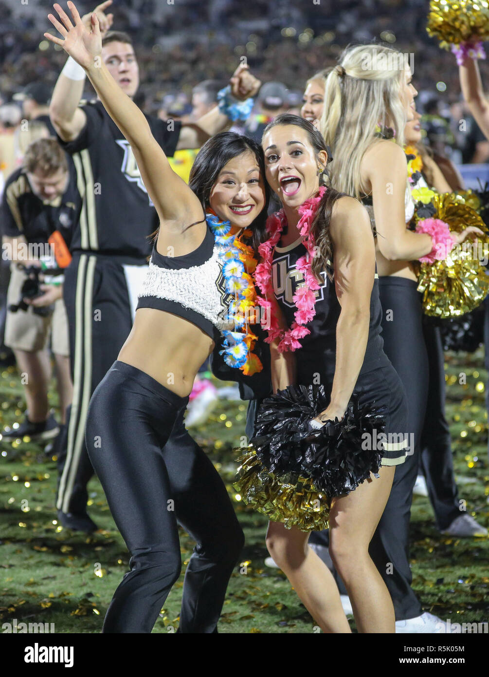 Orlando, Florida, USA. 1st Dec, 2018. A UCF cheerleader and a UCF dancer celebrate the Knight's back-to-back conference championship following the AAC Football Championship game between the Memphis Tigers and the UCF Knights at Spectrum Stadium in Orlando, Florida. Kyle Okita/CSM/Alamy Live News Stock Photo