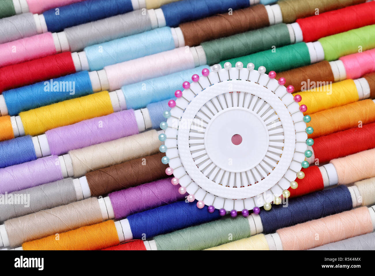 spool of threads and sewing needle Stock Photo Alamy