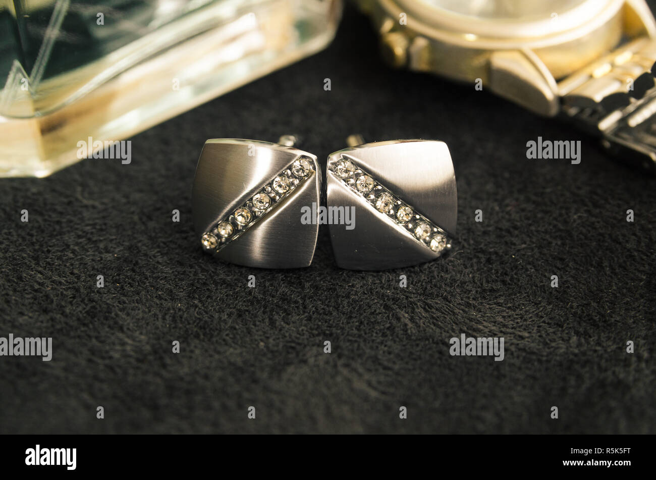 Silver cufflinks and gold watch Stock Photo Alamy