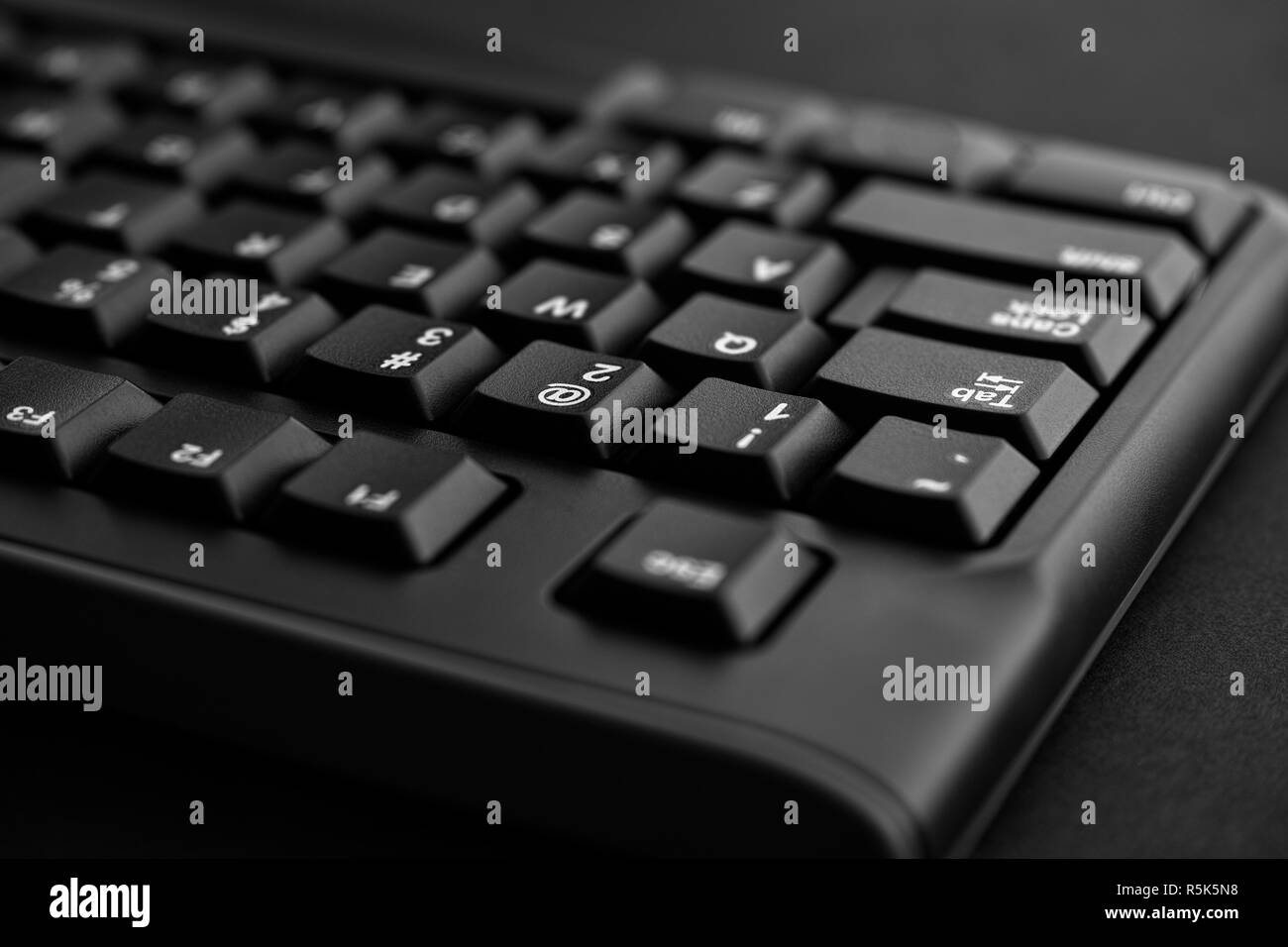 Black keyboard on a black background. Close up. Stock Photo