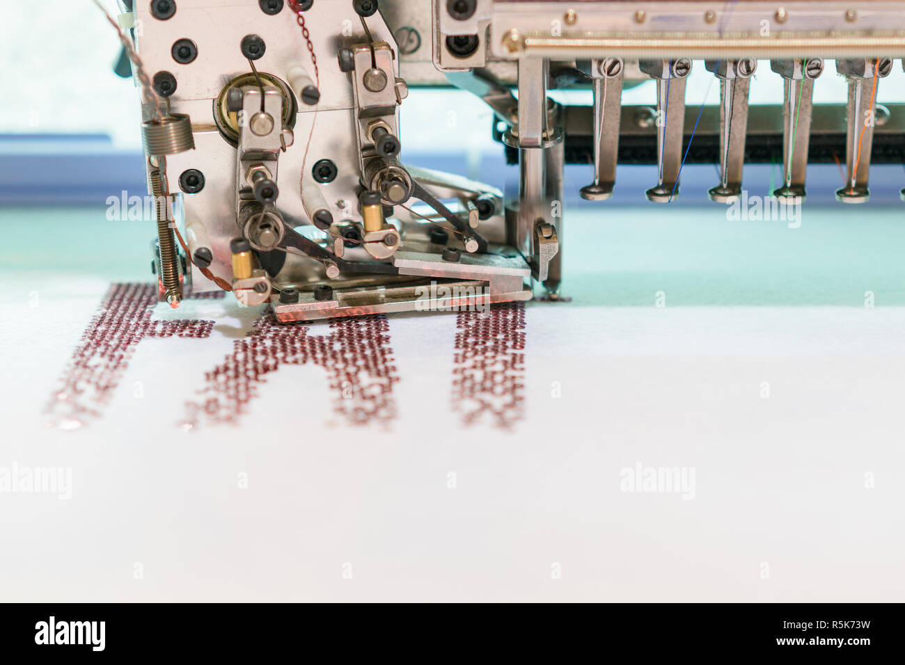 Computerized embroidery machines. sewing machine on blurred background