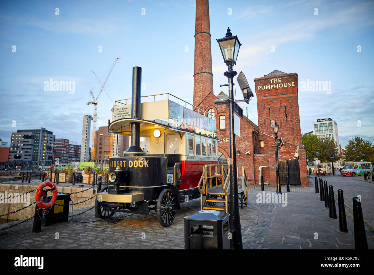 Pier head Liverpool Waterfront promenade Royal Albert Dock The Pump House pub and a ic cream stall steam bus Stock Photo