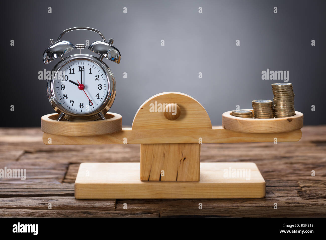 Clock And Coins Balancing On Wooden Weighing Scale Stock Photo Alamy