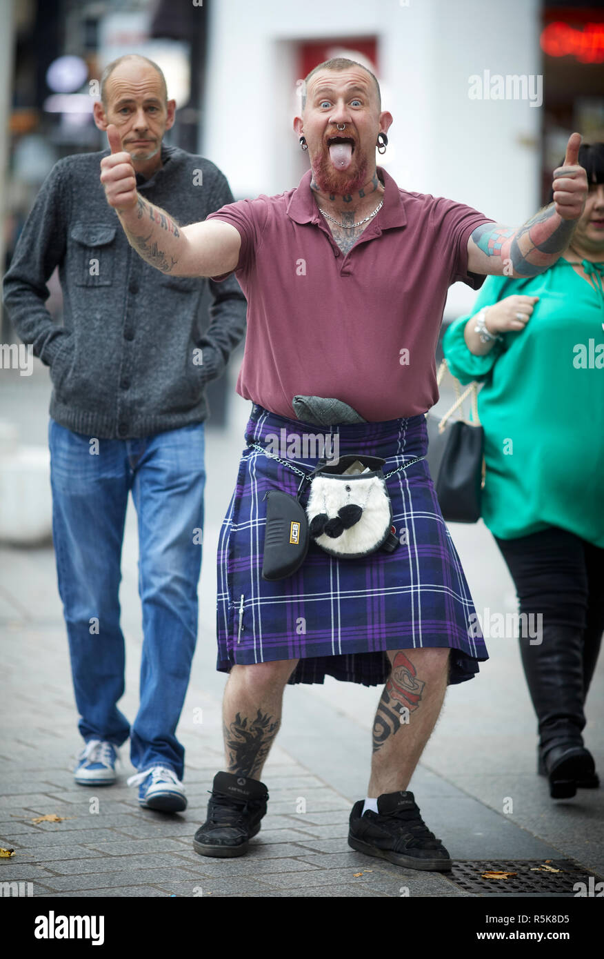 Liverpool city centre Scottish man in kilt plus his young out I'm fun Stock Photo