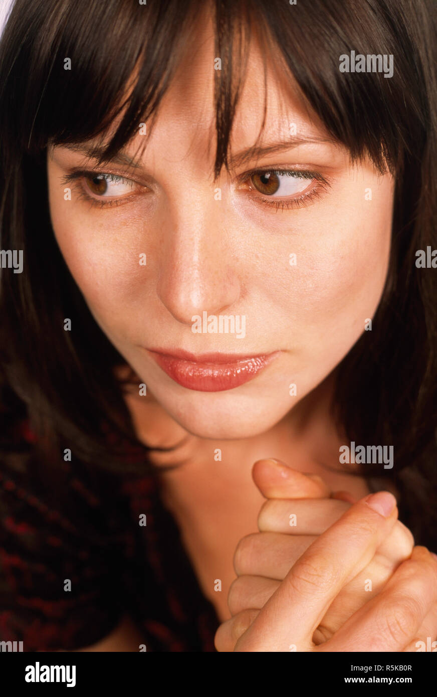 Close up of young woman wringing her hands with worry, USA Stock Photo