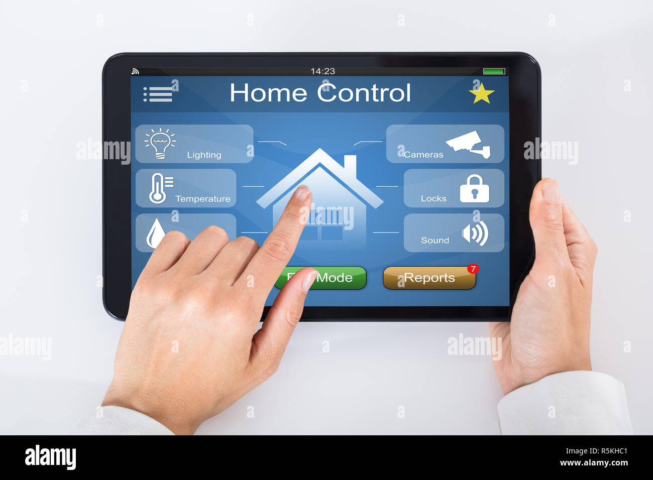 Person Using Home Control System On Digital Tablet Stock Photo