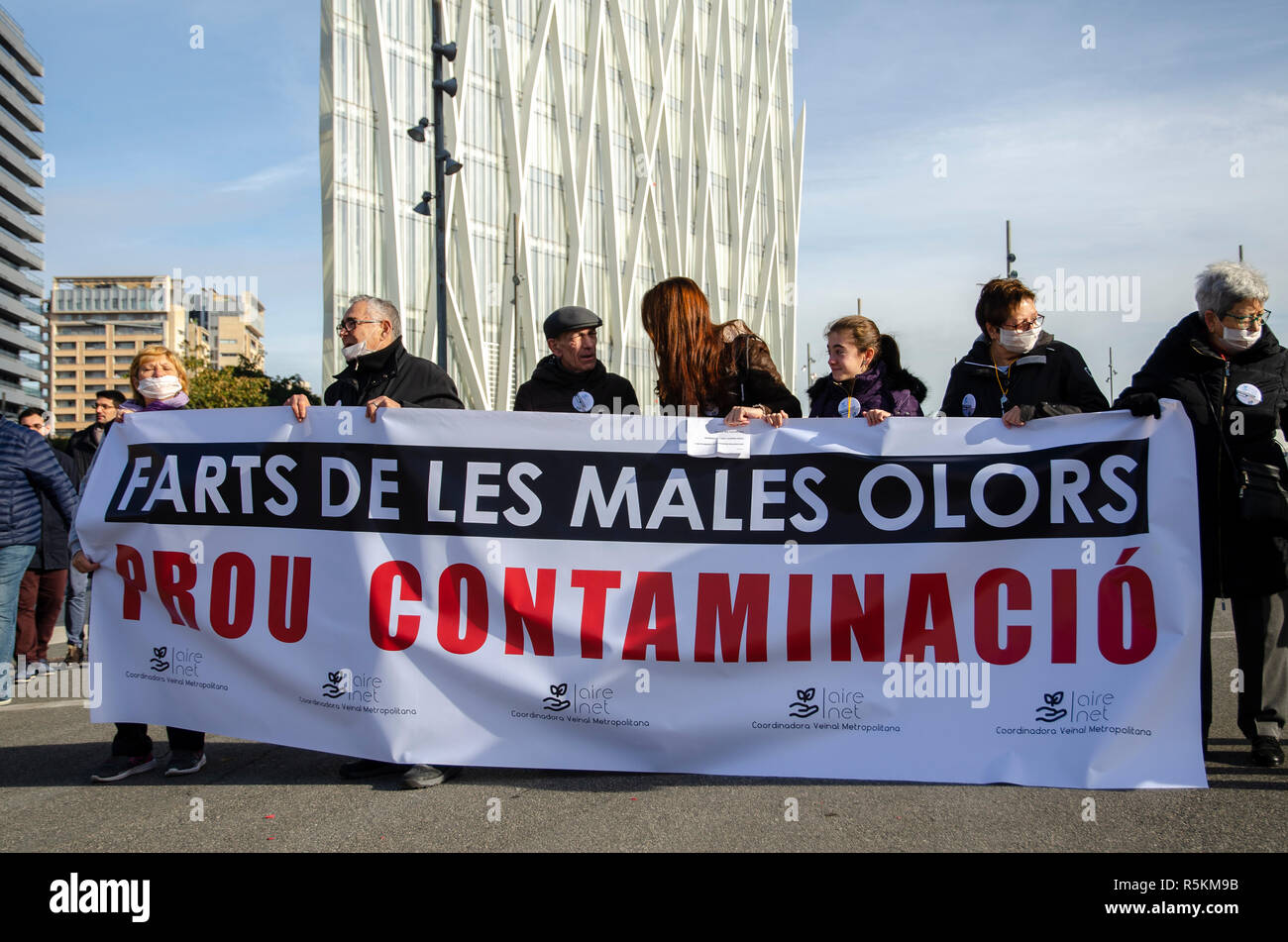 Demonstrators are seen behind a banner calling for an end to the contamination of the Forum area during the protest. Some 300 residents affected by the bad smells and air pollution of the Tersa public incineration plant manifested  demanding that the City Council of Barcelona definitively closes the incinerator plant. Tersa incinerates garbage and generates electricity. Stock Photo