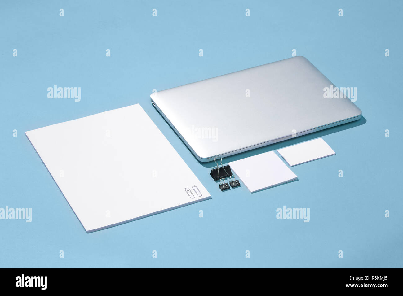 The laptop, pens, phone, note with blank screen on table Stock Photo