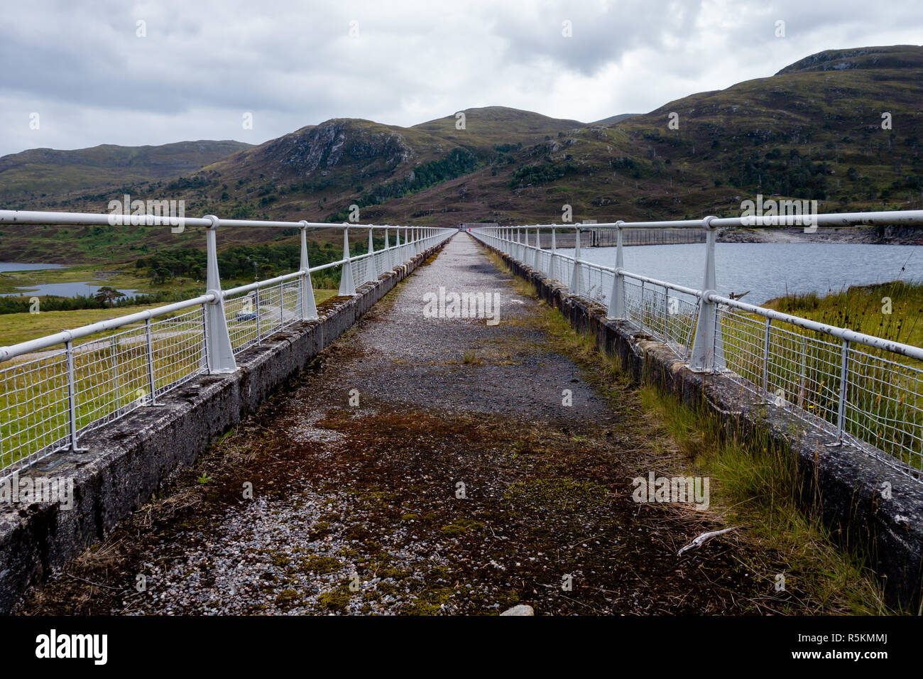 Walking path on top of hydroelectric dam wall in Scotland Stock Photo