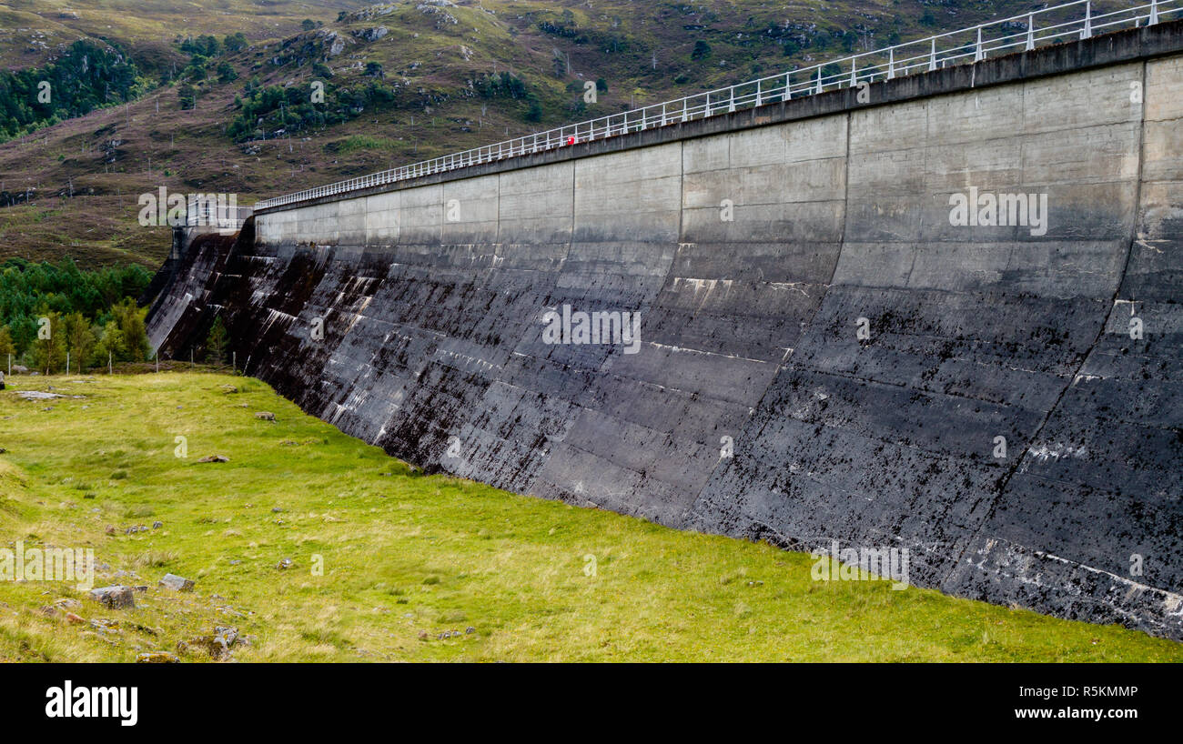 Hydroelectric power water dam wall in concrete between mountain hillsides Stock Photo