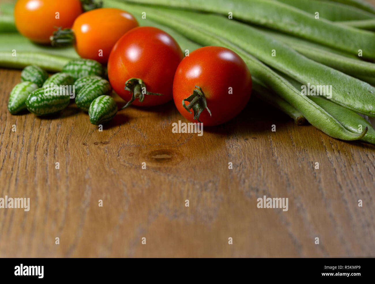 Cucamelons, orange and red tomatoes and runner beans Stock Photo