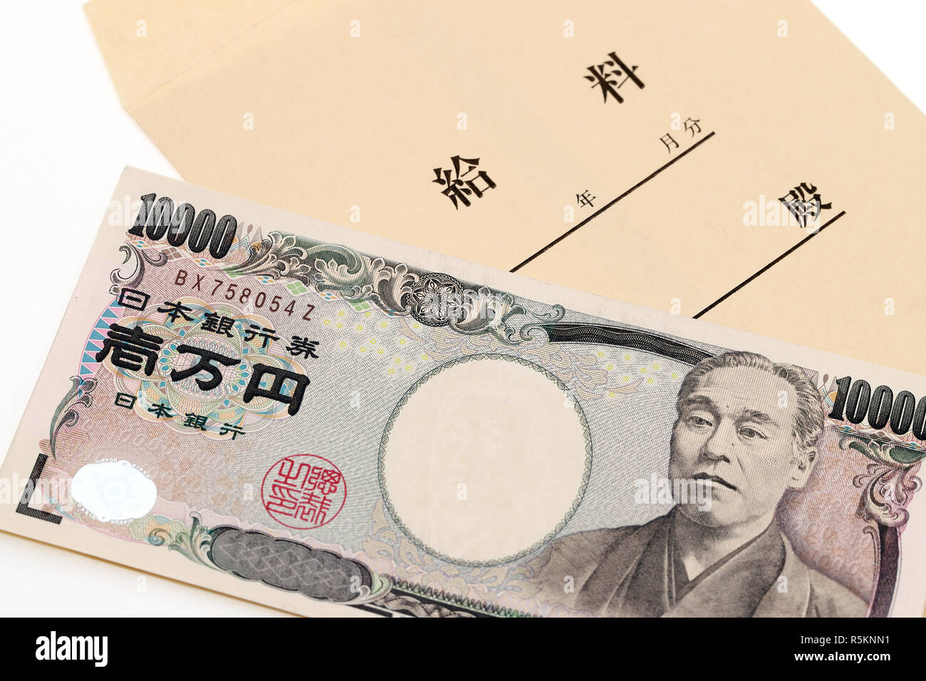 Japanese money and salary envelope on white background Stock Photo - Alamy