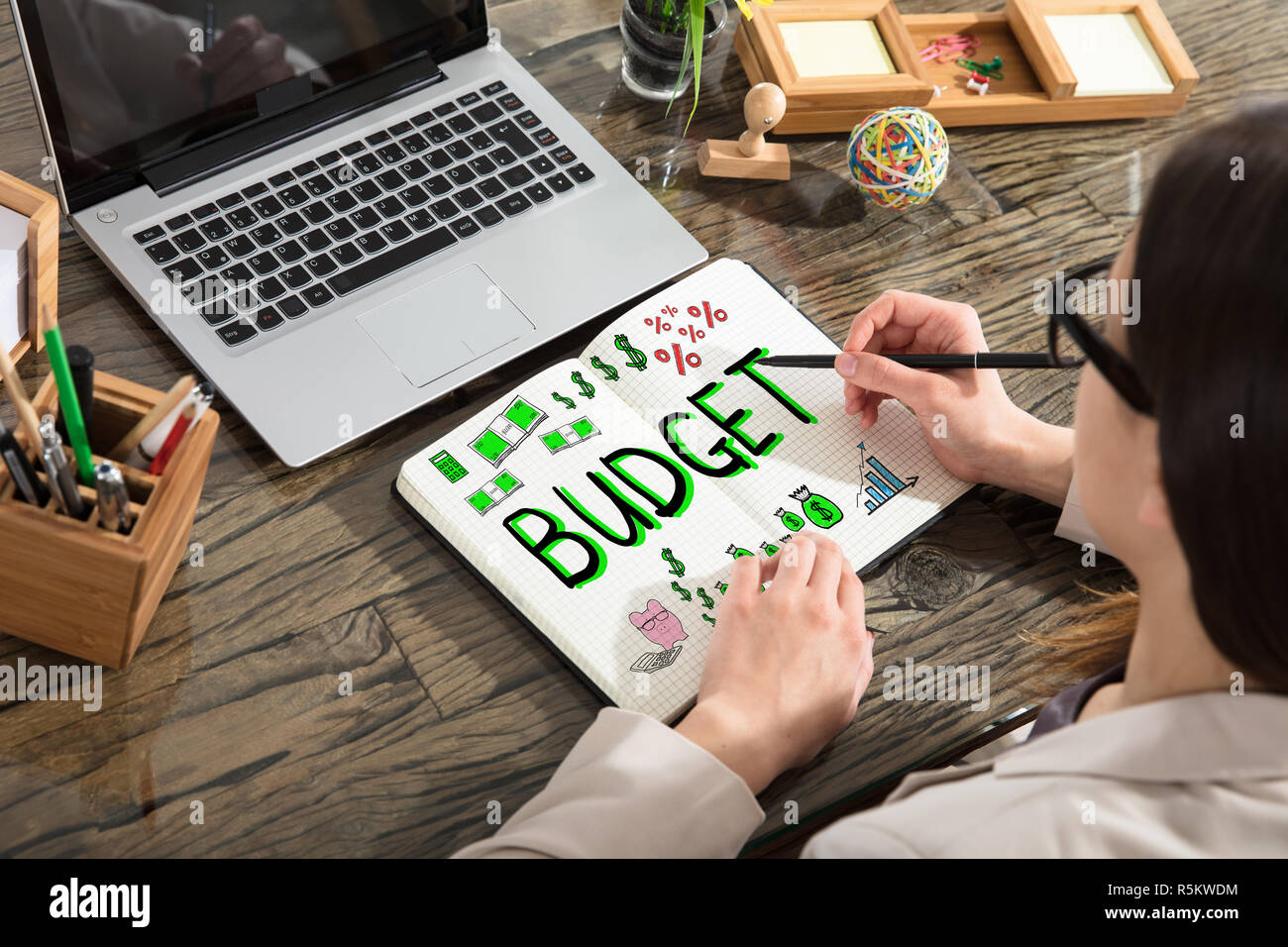 Woman Drawing Budget And Expenses Plan Stock Photo Alamy