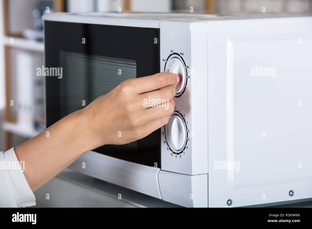 Woman Using Microwave Oven Stock Photo Alamy