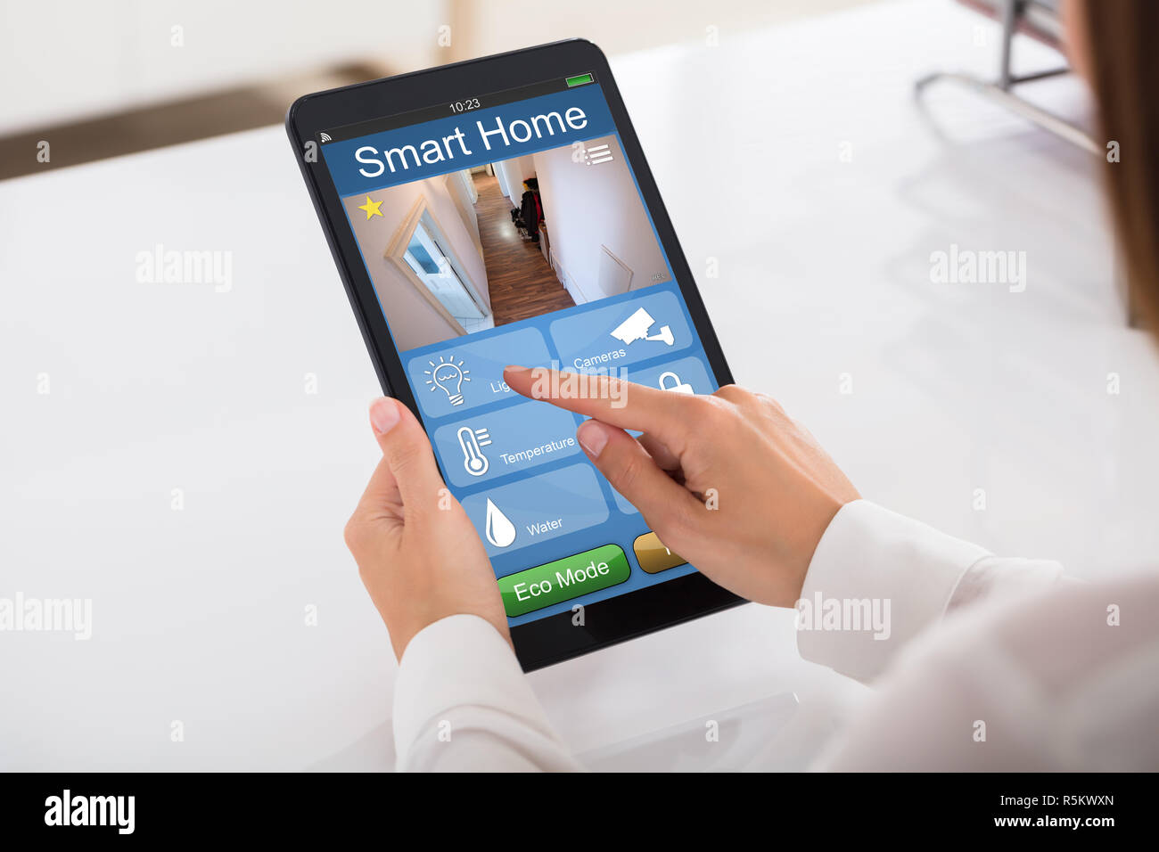 Person Using Smart Home System On Digital Tablet Stock Photo