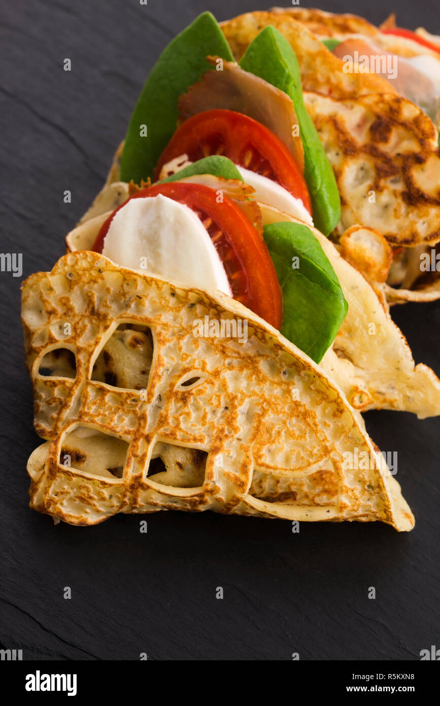 pancakes sutffed with ham,cheese,tomatoes and spinach Stock Photo