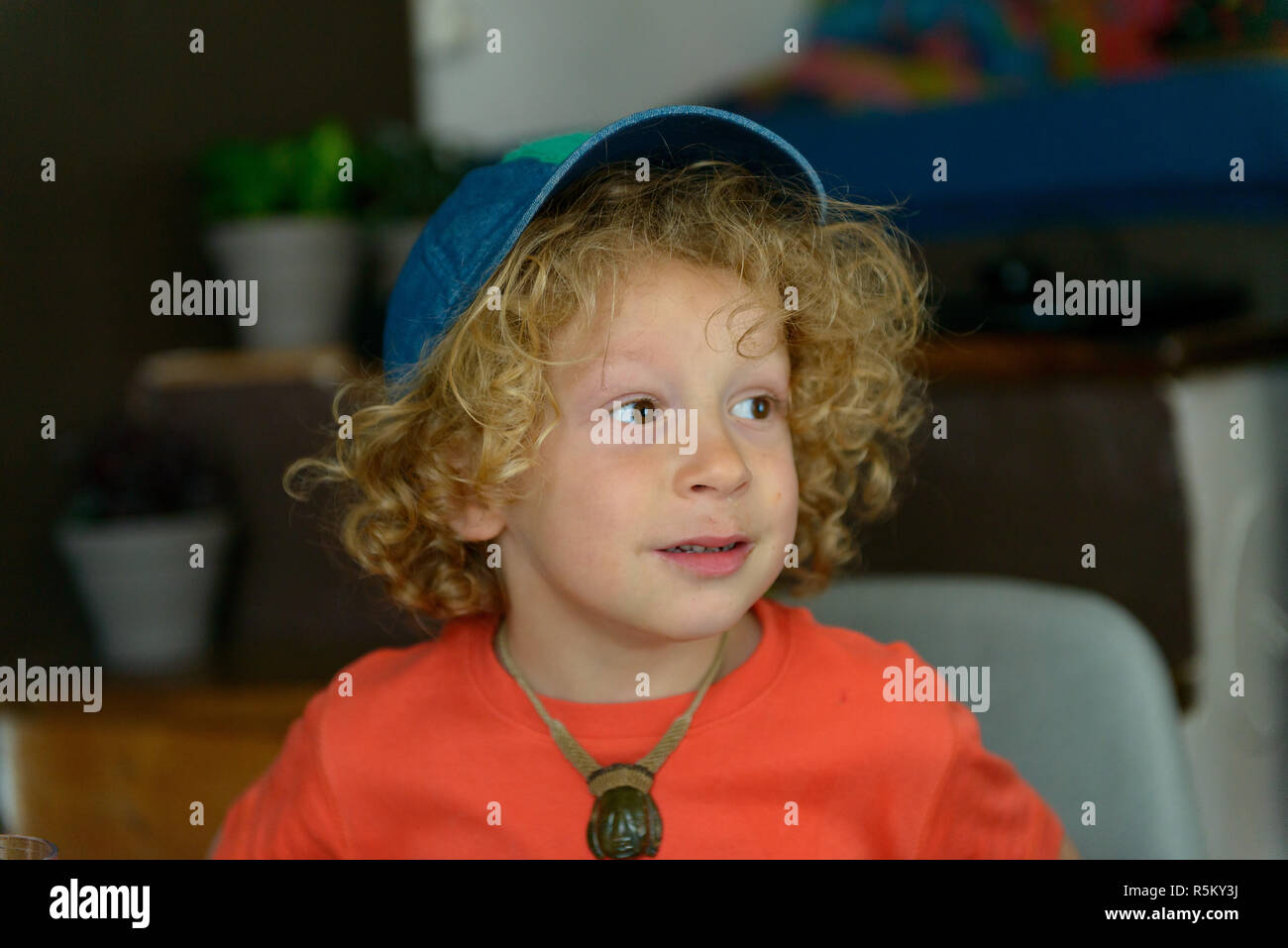 Portrait Of Little Boy With Blond And Curly Hair Stock Photo