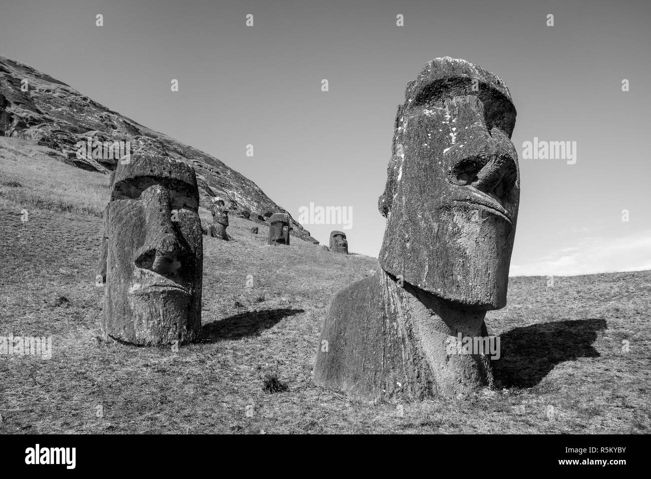 Moais statues on Rano Raraku volcano, easter island. Black and white picture Stock Photo