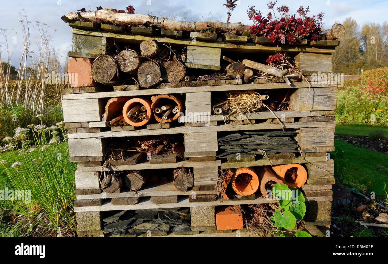 Bug Hotel or wildlife shelter to provide dry and warm conditions for nesting and hibernating insects, invertebrates, frogs, etc. Stock Photo
