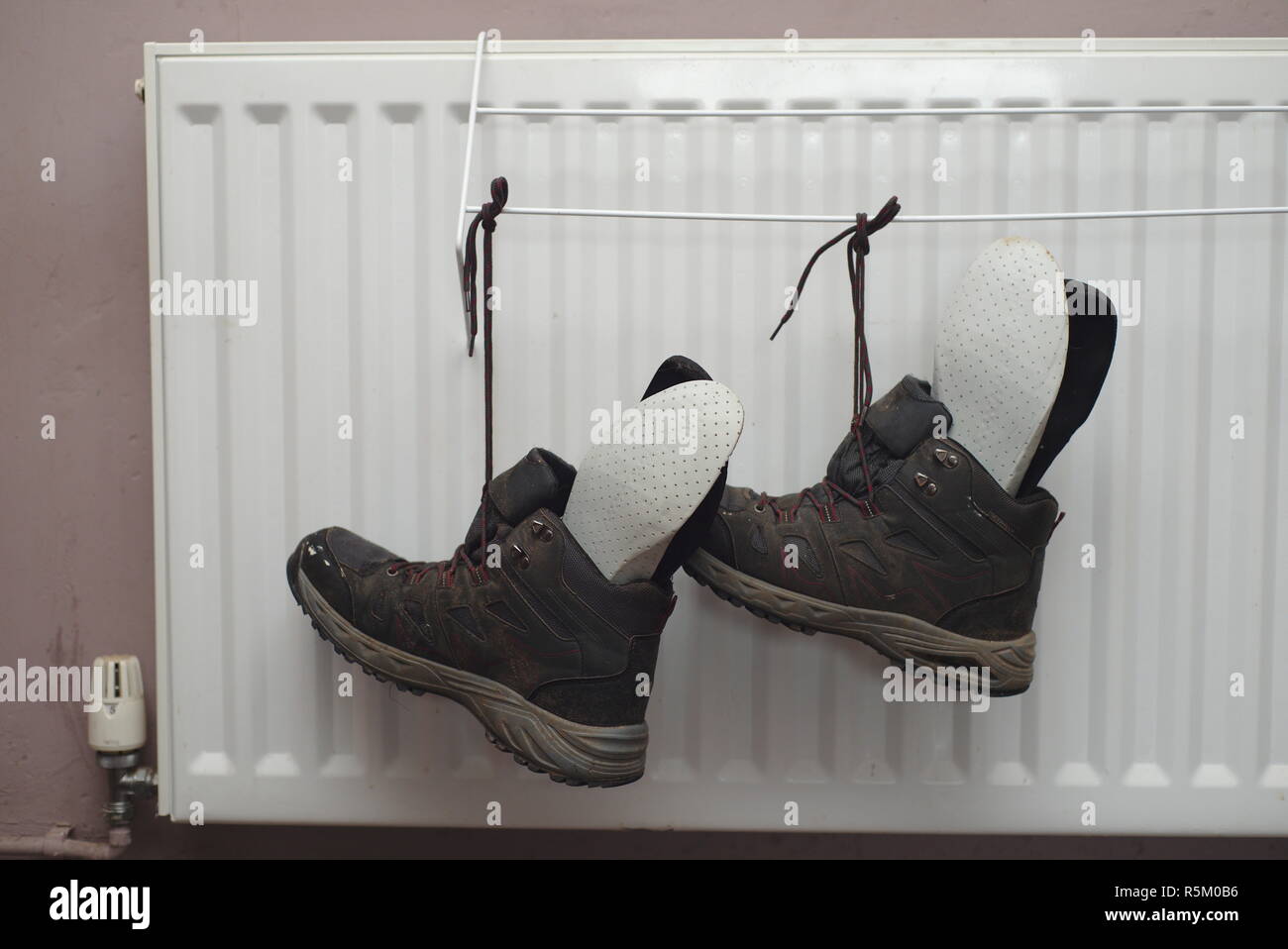 Drying wet boots on radiator Stock Photo Alamy
