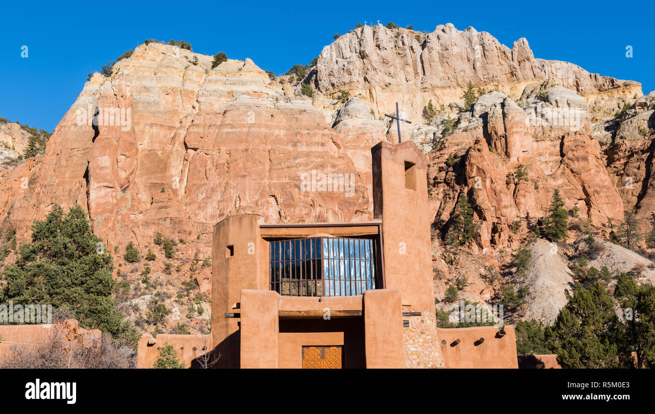 Panorama of high colorful cliffs and rock formations and the Abbey Church at the Monastery of Christ in the Desert near Abiquiu, New Mexico Stock Photo