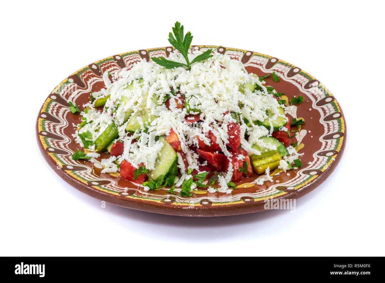 Traditional bulgarian Shopska salad isolated on white bakcground. Made by classic recepie. Stock Photo
