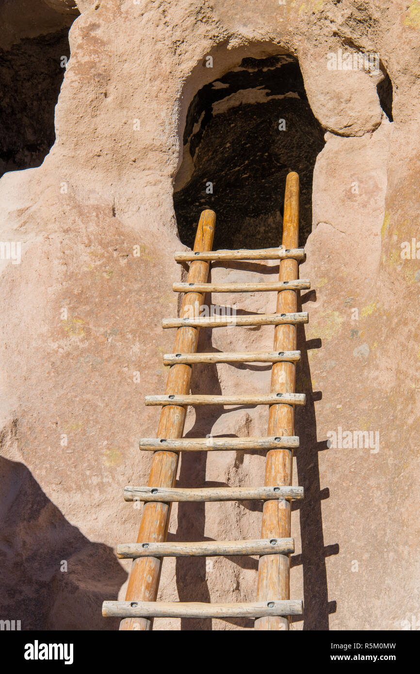 Wood ladder leading to an abandoned cliff dwelling in a cave in Bandelier National Monument near Santa Fe, New Mexico Stock Photo
