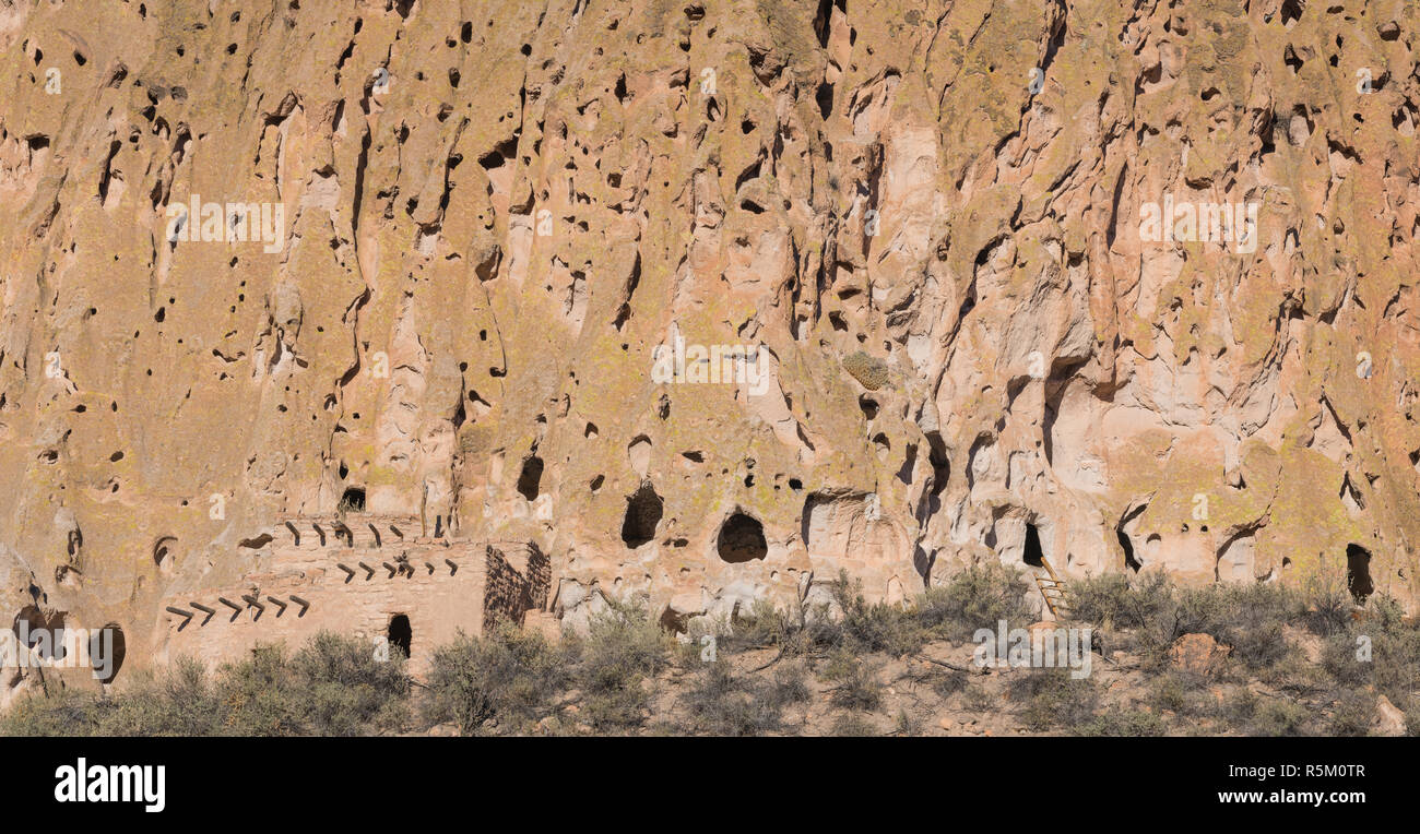 Panorama of abandoned ancient cliff dwellings and caves in a colorful cliff face in Bandelier National Monument near Santa Fe, New Mexico Stock Photo
