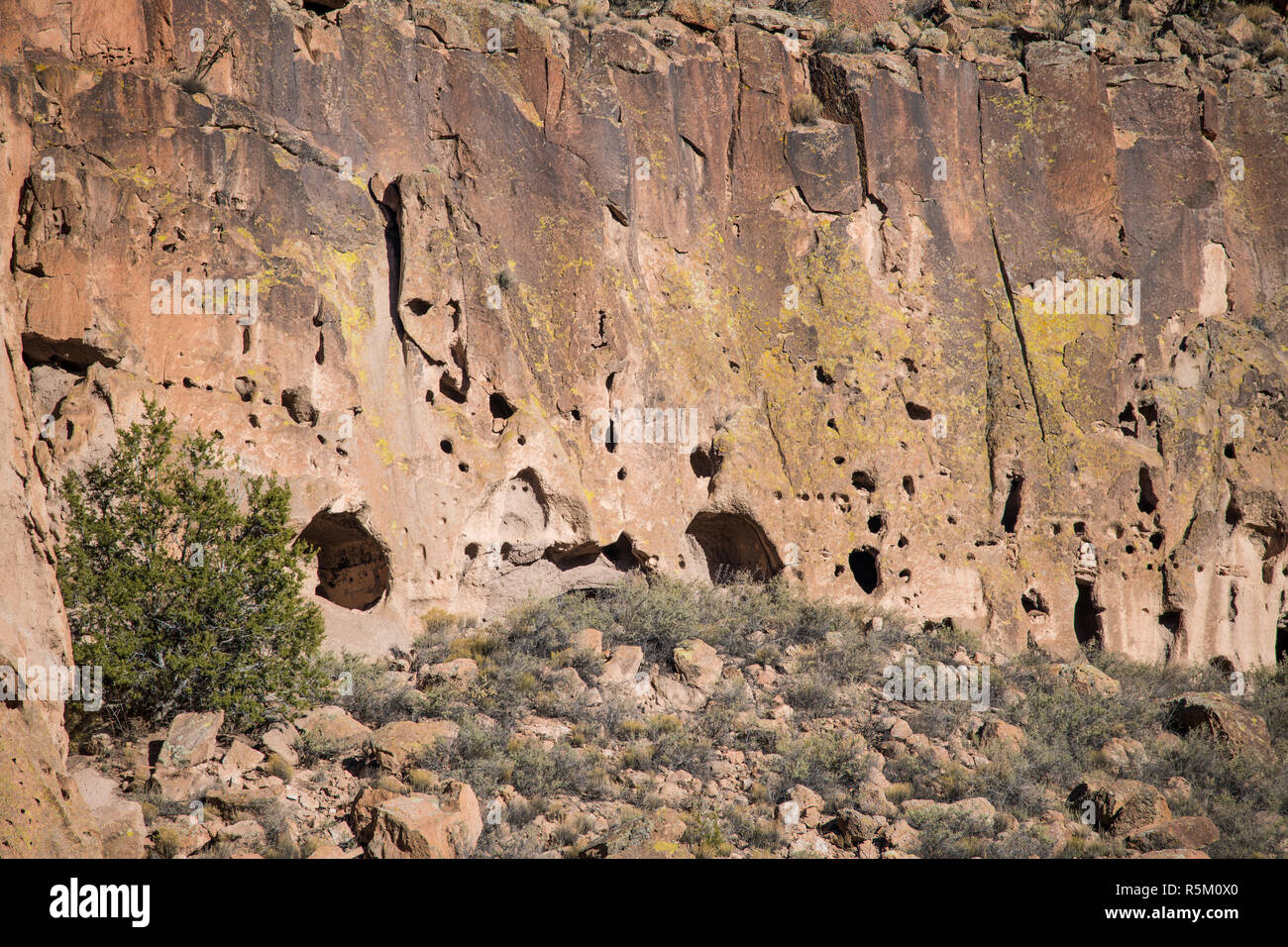 Caves and abandoned ancient ruins in a colorful cliff in Bandelier National Monument near Santa Fe, New Mexico Stock Photo