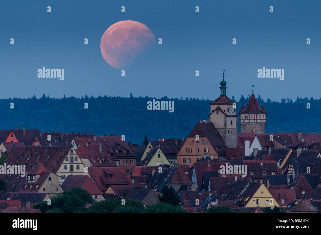 skyline of rothenburg ob der tauber with partial lunar eclipse Stock Photo