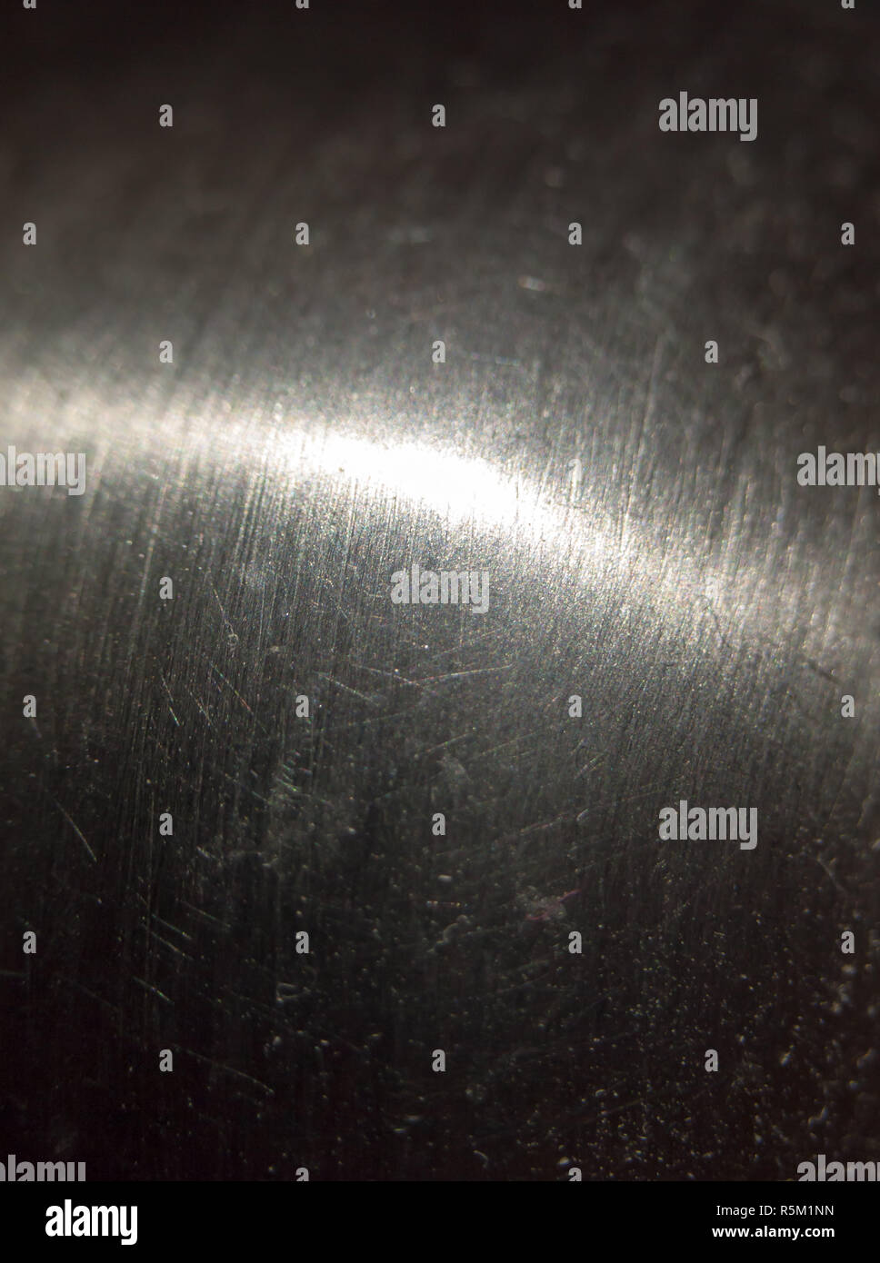 close up scratched metal surface with light across Stock Photo