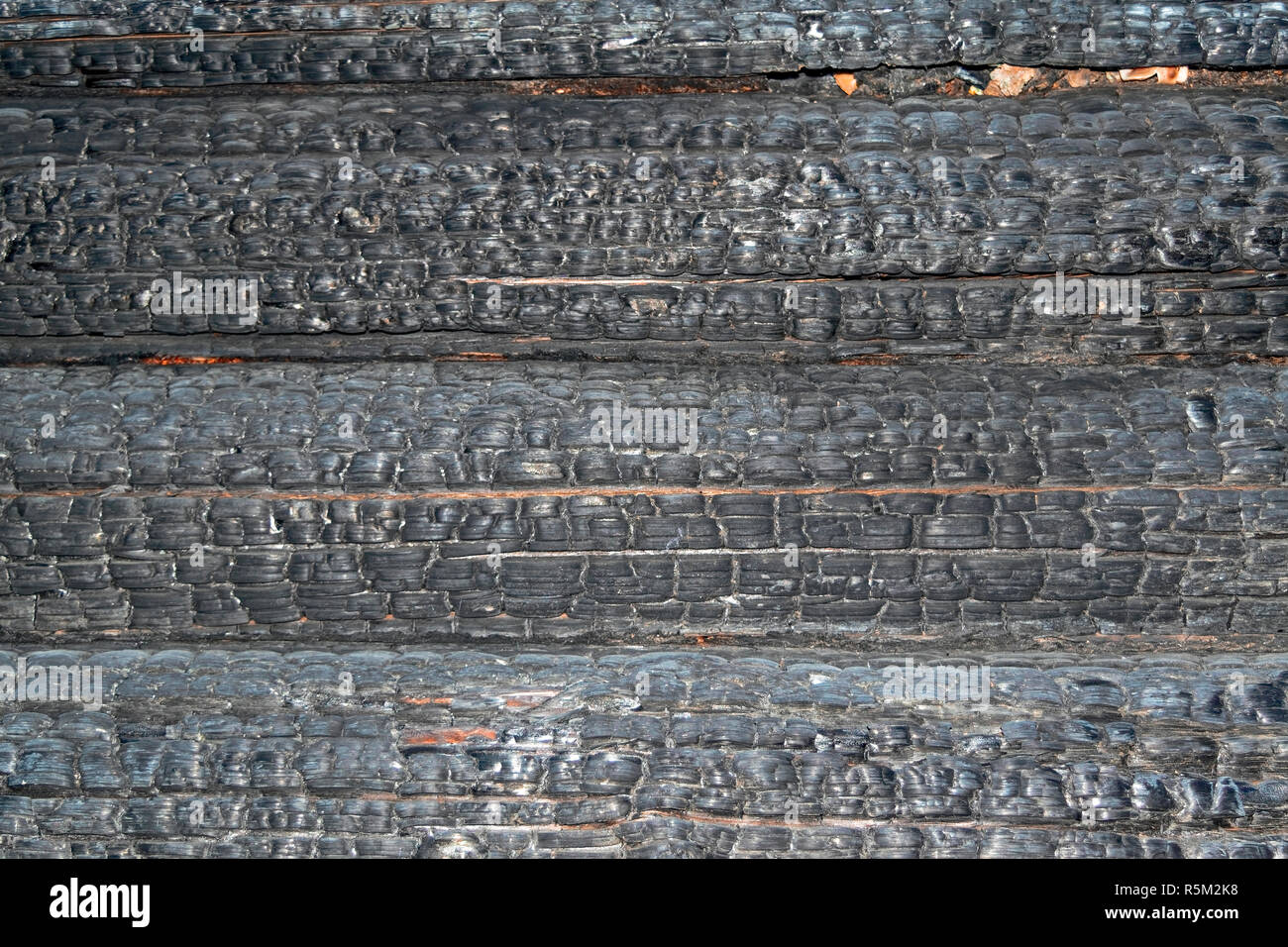 Texture of charred logs. Burned wooden charred log house texture. closeup Stock Photo