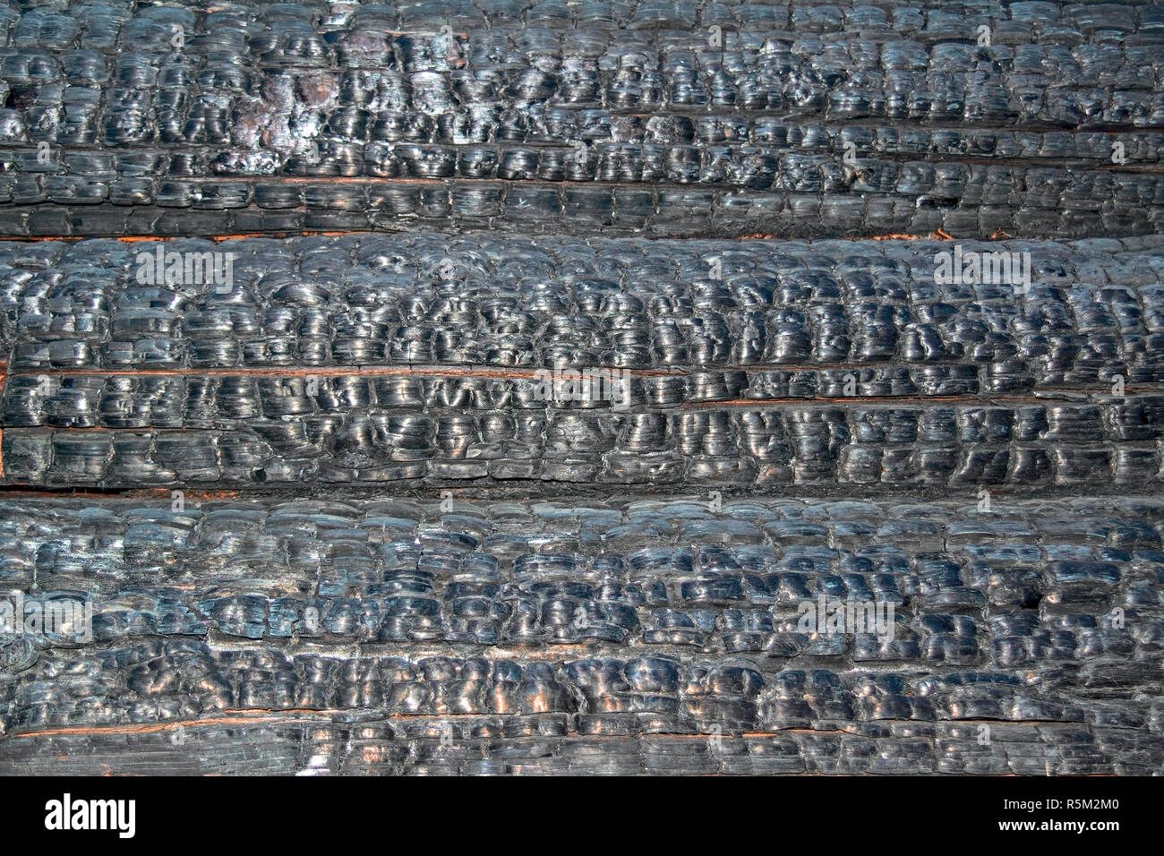 Texture of charred logs. Burned wooden charred log house texture. closeup Stock Photo