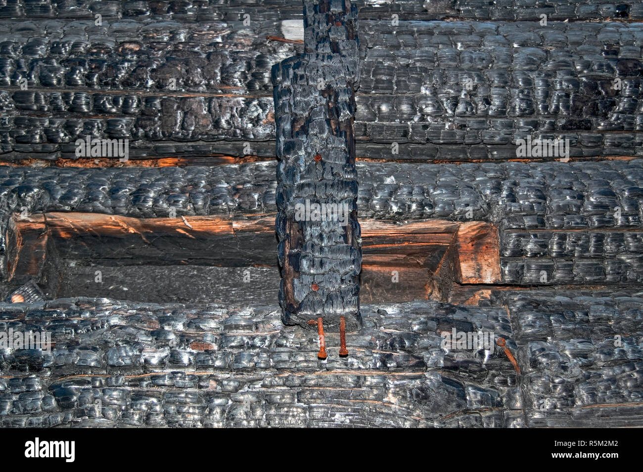 Texture of charred logs. Burned wooden charred log house texture. closeup Stock Photo